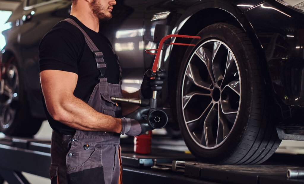 Man is doing balancing for tyres